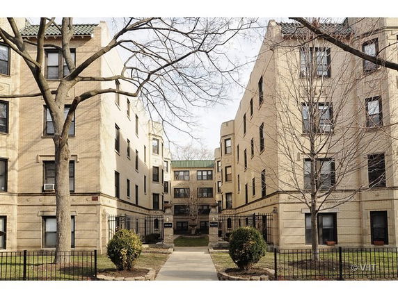Front view of a multi-story apartment building complex.