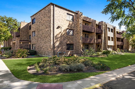 Front view of a multi-story brick apartment building.