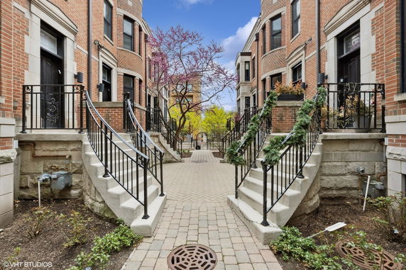 Front view of a residential building with steps leading to the entrance.
