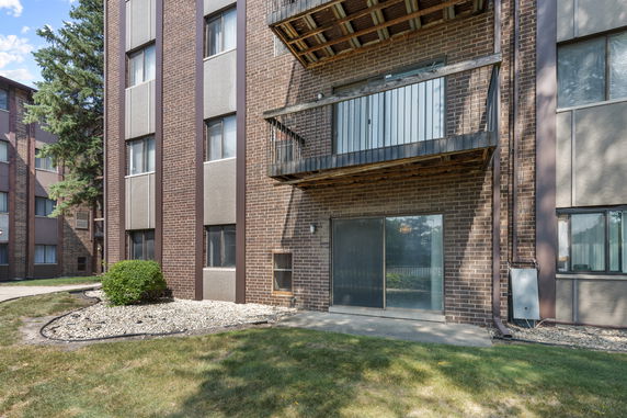 Front view of a multi-story brick building with balconies.
