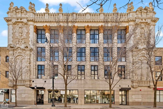 Front view of an ornate multi-story building with detailed architectural features.