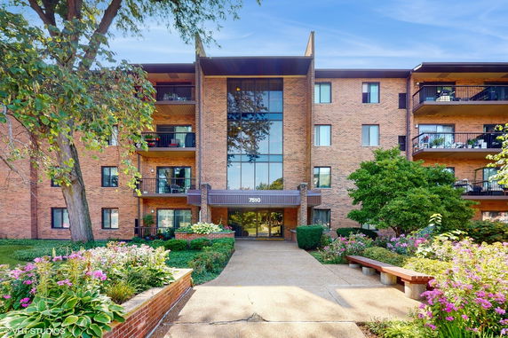 Front view of a multi-story brick building with balconies.