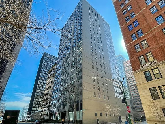 Front view of a tall office building in a city environment.