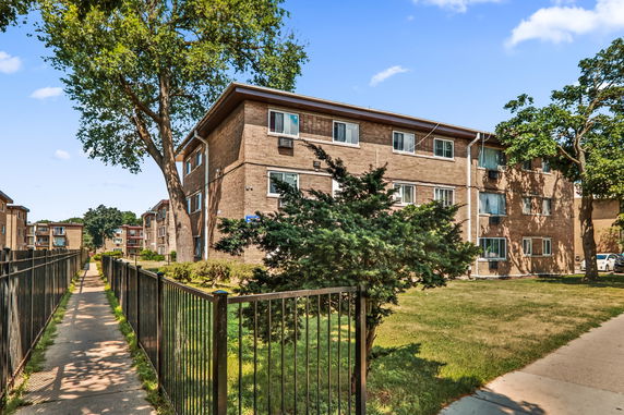 Front view of a multi-story brick apartment building.