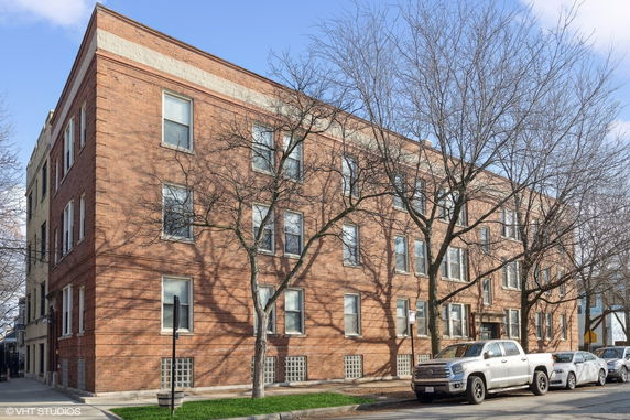 Front view of a three-story brick apartment building.