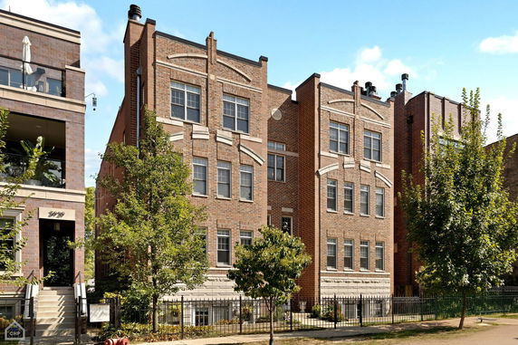 Front view of a multi-story brick apartment building.