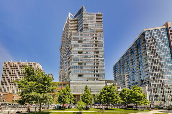 Front view of a high-rise building with glass facade.