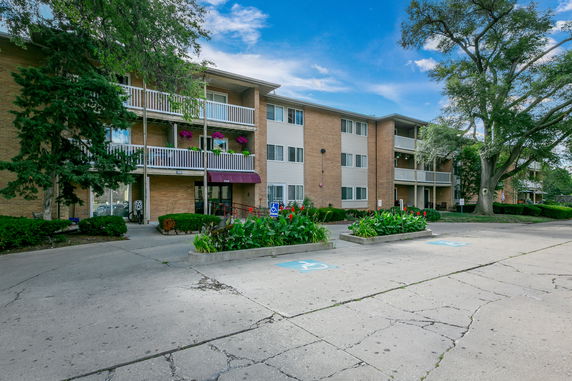Front view of a multi-story apartment building with balconies.