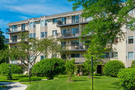 Front view of a multi-story apartment building with balconies.