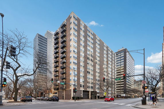 Front view of a multi-story building with multiple balconies and large windows.