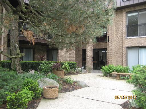 Front view of a multi-story building with brick exterior and large windows.