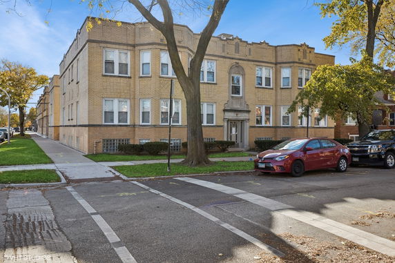 Front view of a multi-story brick apartment building.