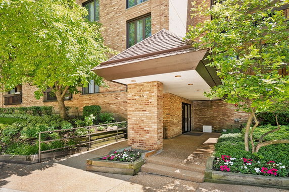 Front view of a building with brick exterior and covered entrance.