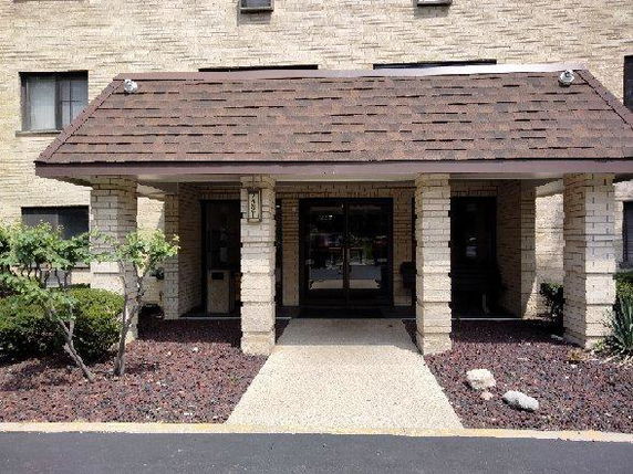 Front view of a building entrance with a covered porch.