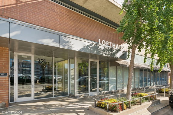 Front view of a modern commercial building with large glass doors and windows.