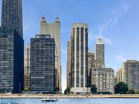 View of a cityscape with tall buildings by the waterfront.