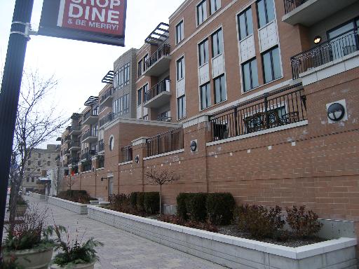 Front view of a multi-story apartment building with balconies.