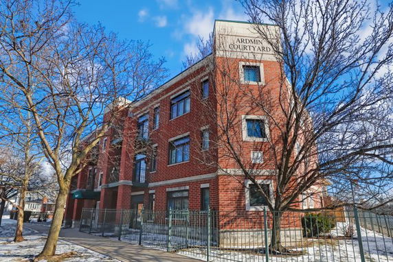 Front view of a multi-story brick building named 'Ardmin Courtyard'.