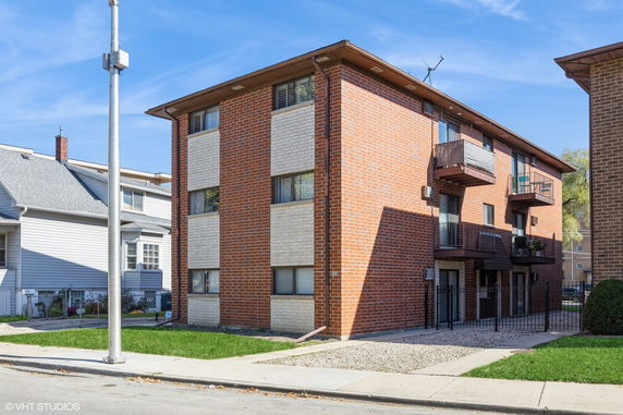 Front view of a three-story brick apartment building.