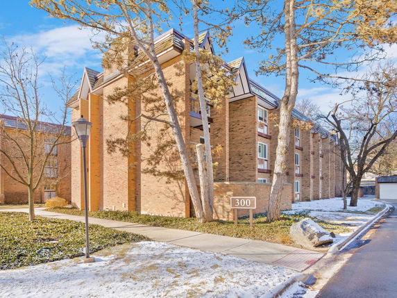 Front view of a multi-story brick apartment building.