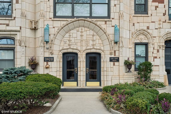 Front view of a building with ornate architectural details and double doors.