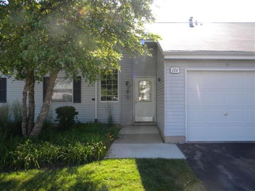 Front view of a house with attached garage and a small front porch.