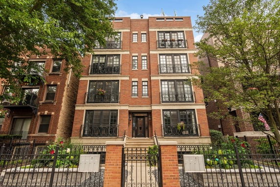 Front view of a multi-story brick building with balconies.