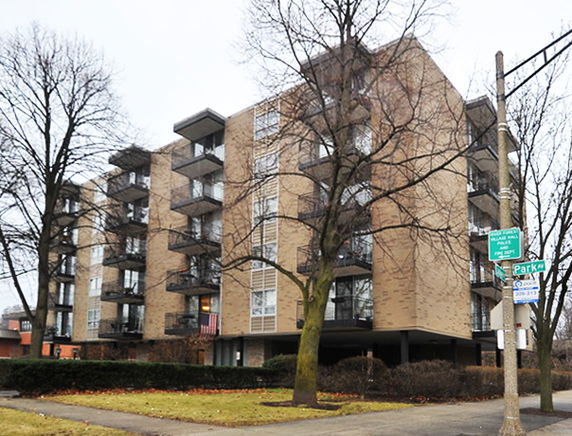 Front view of a multi-story apartment building with balconies.