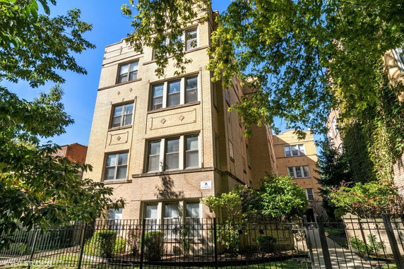 Front view of a multi-story brick apartment building.