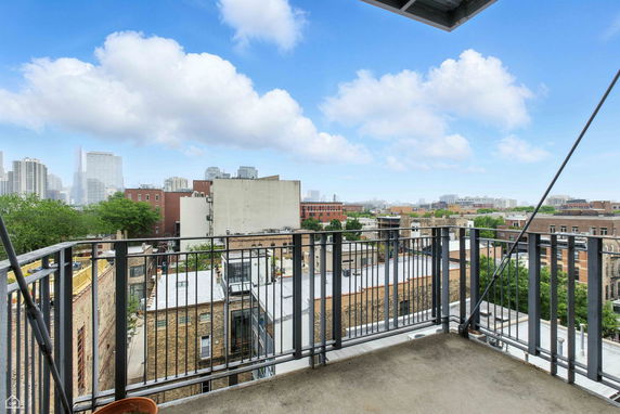 Balcony view overlooking city buildings and skyline