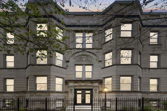 Front view of a multi-story building with ornate detailing.