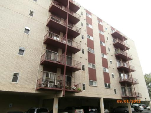 Front view of a multi-story residential building with balconies.