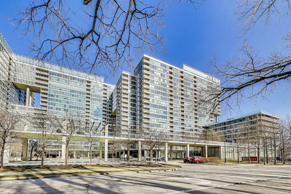 Front view of a modern multi-story building with extensive glass windows.