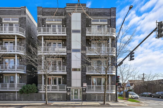 Front view of a multi-story building with balconies.