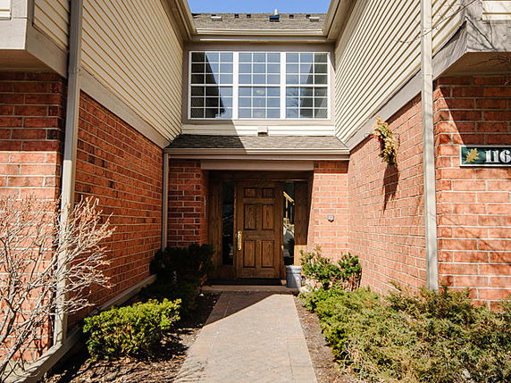 Front view of a two-story house with brick and siding exterior.