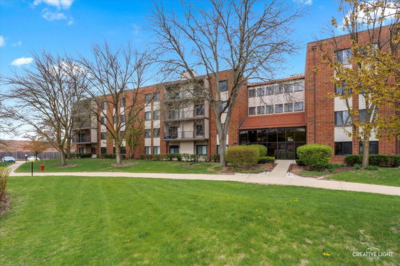 Front view of a multi-story residential building with a brick exterior.
