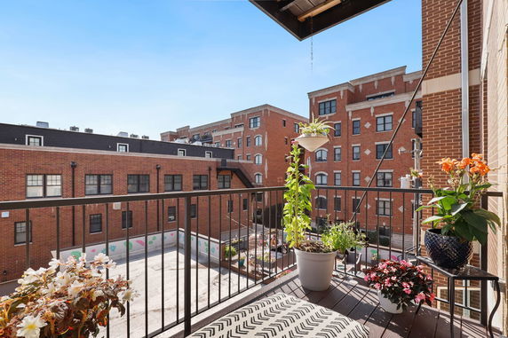 View from a balcony showing adjacent buildings with brick exteriors.