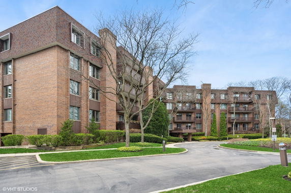 Front view of a multi-story brick apartment building.