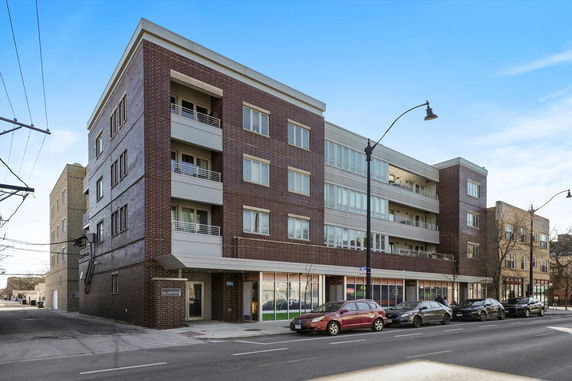 Front view of a multi-story apartment building with balconies.