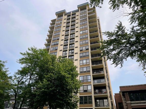 Front view of a multi-story residential building with balconies.