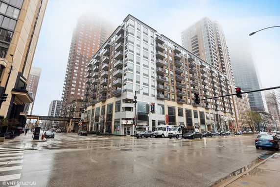 Front view of a multi-story apartment building on a city corner.