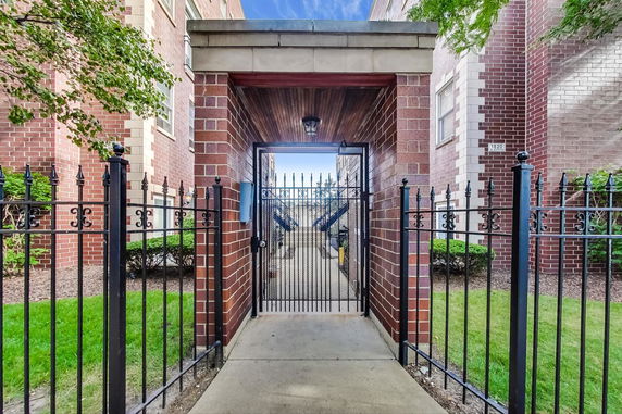 Front view of a gated entrance to a brick building.