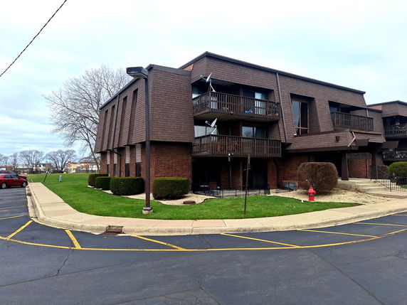 Front view of a multi-story building with balconies.