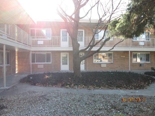 Front view of a two-story building with a courtyard.