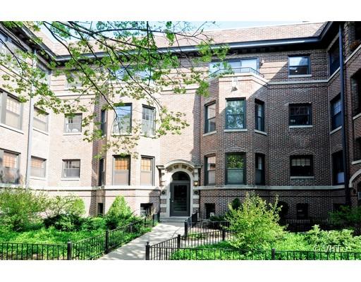 Front view of a multi-story brick building with a central entrance.