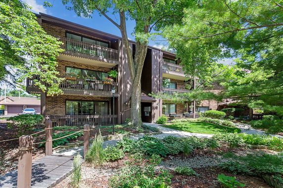 Front view of a multi-story brick building with balconies.