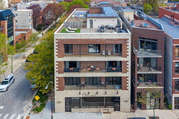 Front view of a multi-story brick building with balconies.
