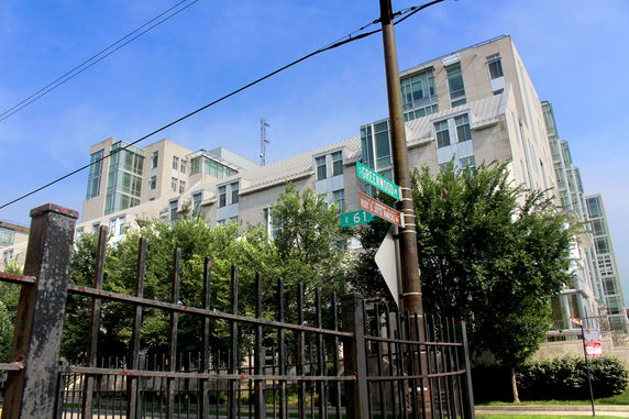 Front view of a modern multi-story building with large windows.