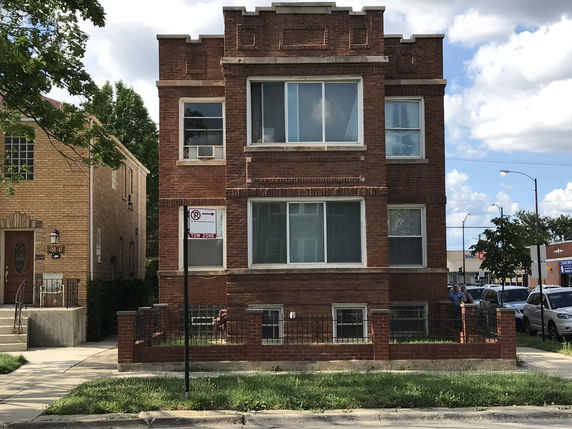 Front view of a multi-story brick building.