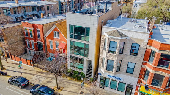 Aerial view of a residential street with multiple houses, highlighting diverse architectural styles.
